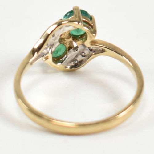 279 - A hallmarked 9ct gold, emerald and diamond crossover ring. The ring set with two four claw round cut... 