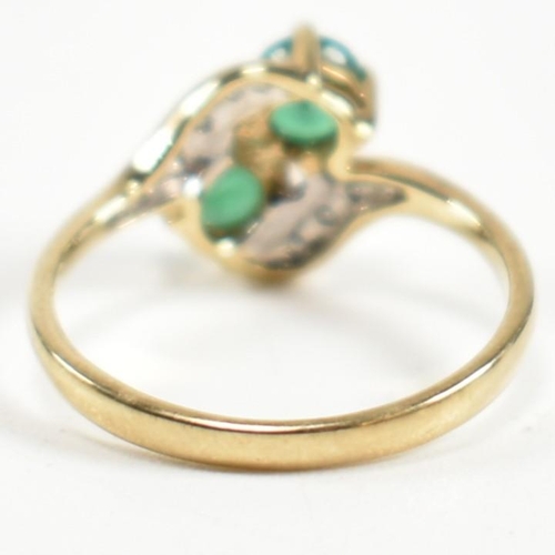 279 - A hallmarked 9ct gold, emerald and diamond crossover ring. The ring set with two four claw round cut... 