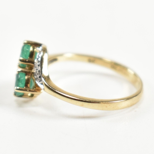 279 - A hallmarked 9ct gold, emerald and diamond crossover ring. The ring set with two four claw round cut... 