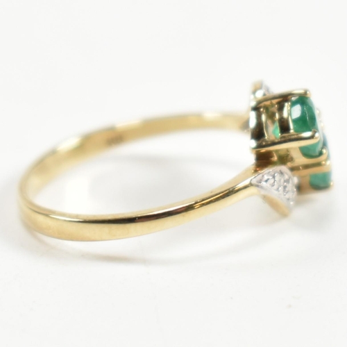 279 - A hallmarked 9ct gold, emerald and diamond crossover ring. The ring set with two four claw round cut... 