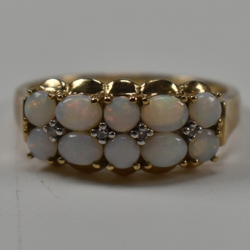 282 - A hallmarked 9ct gold, diamond and opal ring. The ring having two rows of mixed oval and round opal ... 