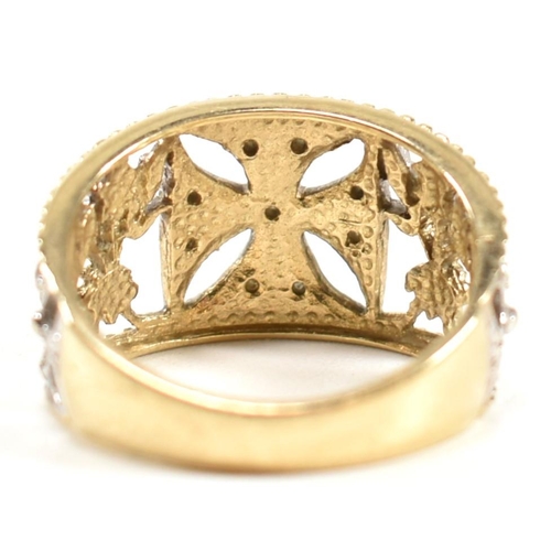 283 - A hallmarked 9ct gold and diamond Maltese cross ring. The pierced band ring having a central white g... 