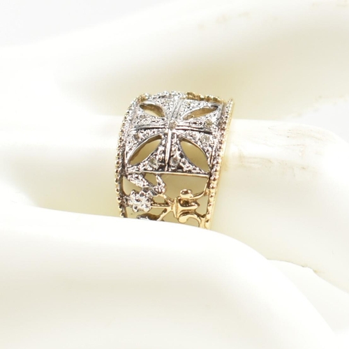 283 - A hallmarked 9ct gold and diamond Maltese cross ring. The pierced band ring having a central white g... 