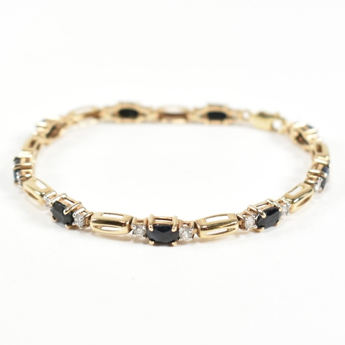 286 - A 9ct gold, sapphire and CZ line bracelet. The bracelet having links set with nine east-west set ova... 