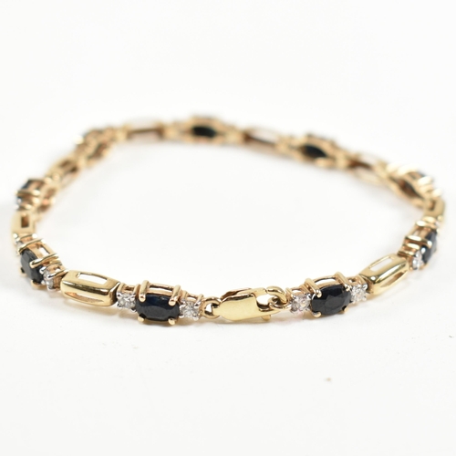 286 - A 9ct gold, sapphire and CZ line bracelet. The bracelet having links set with nine east-west set ova... 