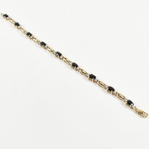 286 - A 9ct gold, sapphire and CZ line bracelet. The bracelet having links set with nine east-west set ova... 