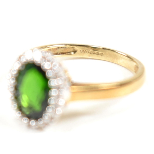 287 - A hallmarked 9ct gold, tourmaline and diamond cluster ring. The ring set with a central oval cut tou... 