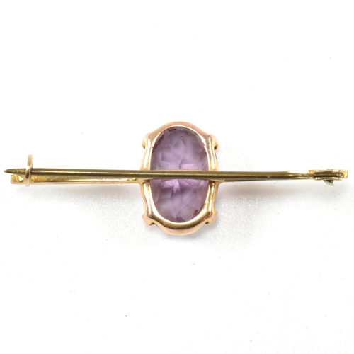 288 - A yellow metal and amethyst bar brooch pin. The brooch marked WBs 9. Tests indicate 9ct gold to the ... 