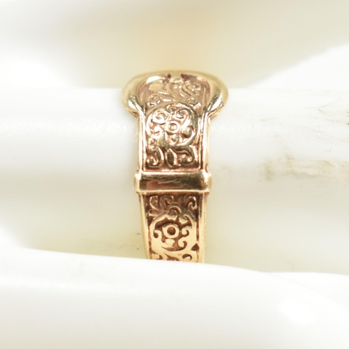 289 - A hallmarked 9ct gold engraved buckle ring. The ring having a belt buckle design with scrolling deco... 