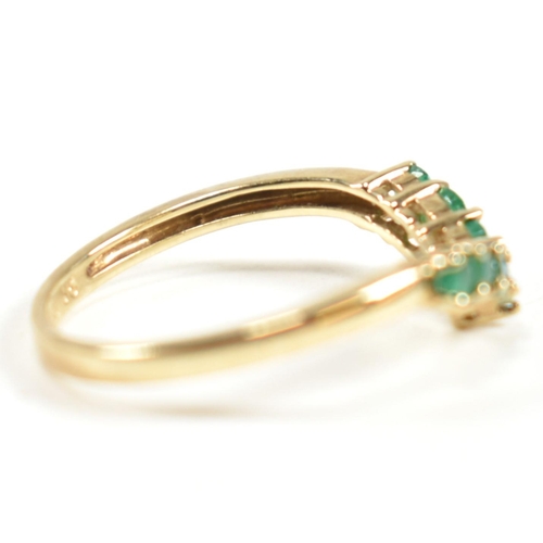 292 - A hallmarked 9ct gold and emerald wishbone ring. The ring set with a single row of shared claw round... 