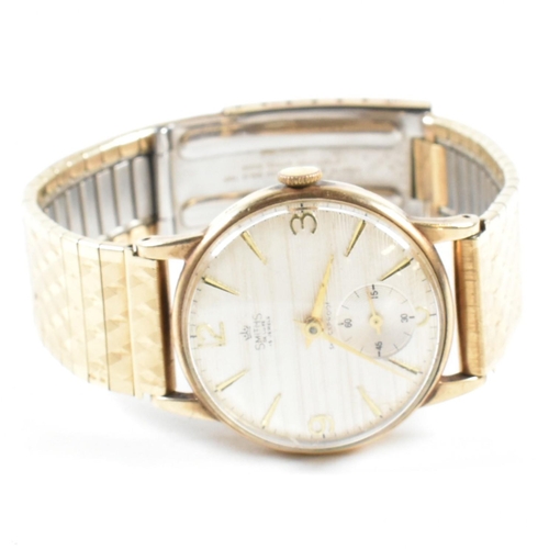 295 - A 9ct gold Smiths De Luxe 15 Jewels wristwatch on a rolled gold strap. The gentleman's wrist watch h... 