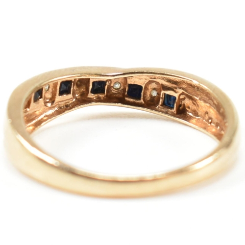 298 - A hallmarked 9ct gold, diamond and sapphire ring. The ring having a single row of five princess cut ... 