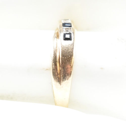 298 - A hallmarked 9ct gold, diamond and sapphire ring. The ring having a single row of five princess cut ... 