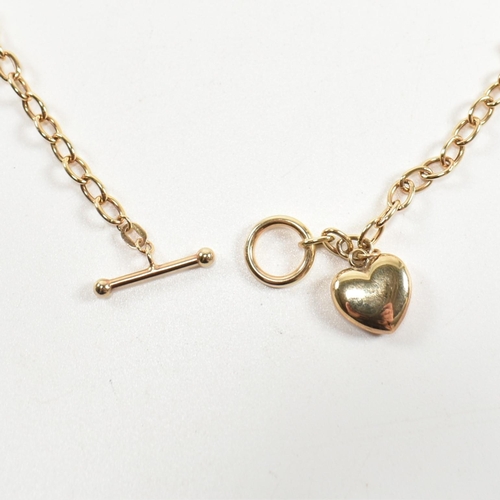 300 - A hallmarked 9ct gold T-bar necklace with heart pendant. The 9ct gold cable chain necklace having a ... 