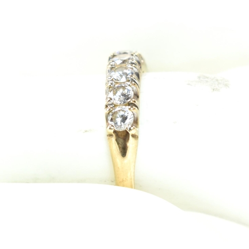 302 - A hallmarked 9ct gold and CZ half hoop ring. The 9ct gold ring having a single row of seven round cu... 