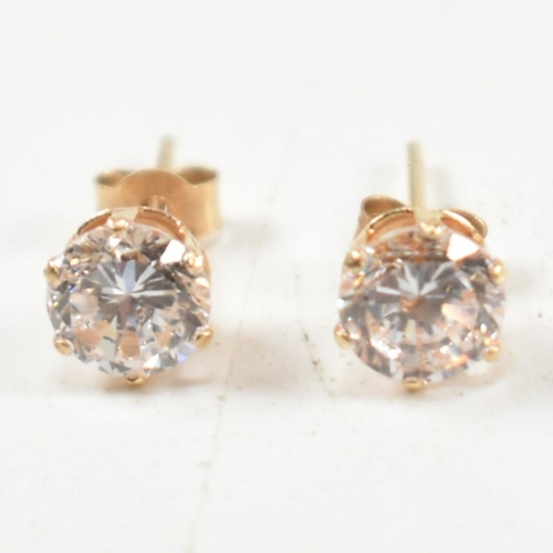 305 - Four pairs of 9ct gold and gem set stud earrings. The earrings to include a pair of 9ct gold faceted... 