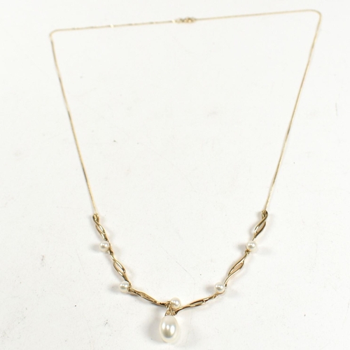 307 - A hallmarked 9ct gold, cultured pearl drop and diamond necklace. The necklace having a cultured pear... 