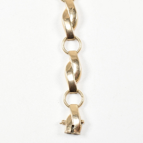 308 - A 9ct gold fancy panel link bracelet. The bracelet formed with crossover and roundel links to concea... 