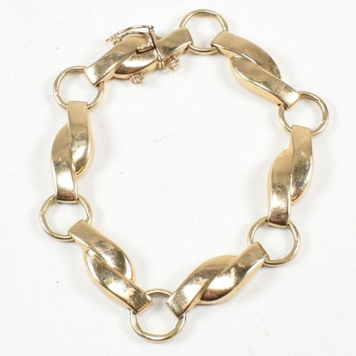 308 - A 9ct gold fancy panel link bracelet. The bracelet formed with crossover and roundel links to concea... 