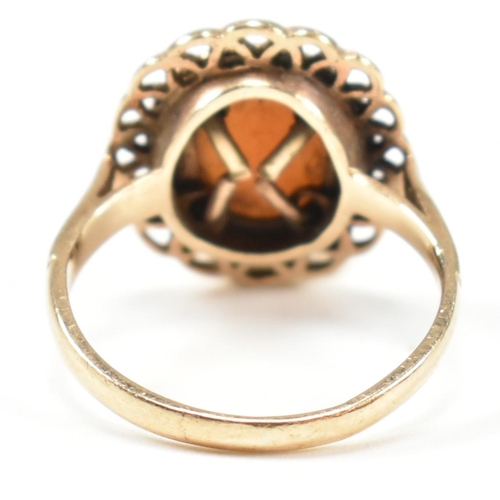 310 - A hallmarked 9ct gold and carved shell cameo ring. The ring having a bezel set carved shell cameo de... 