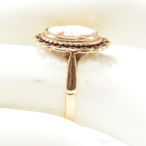 310 - A hallmarked 9ct gold and carved shell cameo ring. The ring having a bezel set carved shell cameo de... 