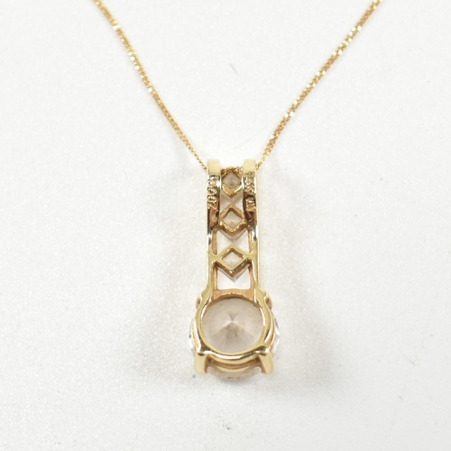 313 - A 14ct gold and gem set pendant necklace. The pendant having a four claw set round cut white stone s... 