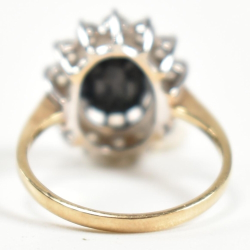 318 - A hallmarked 9ct gold, sapphire and CZ ring. The ring having a central oval cut sapphire surrounded ... 