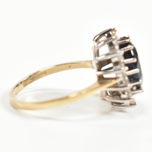 318 - A hallmarked 9ct gold, sapphire and CZ ring. The ring having a central oval cut sapphire surrounded ... 