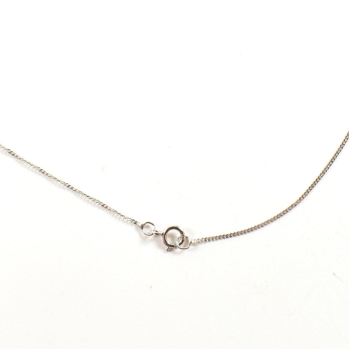 320 - A hallmarked 9ct white gold, diamond and green stone pendant necklace. The pendant set with an oval ... 