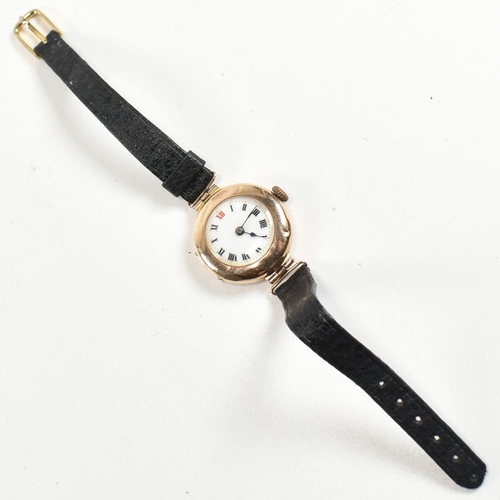 325 - A hallmarked 9ct gold wristwatch with a black strap. The watch having Roman numeral indices, spade h... 