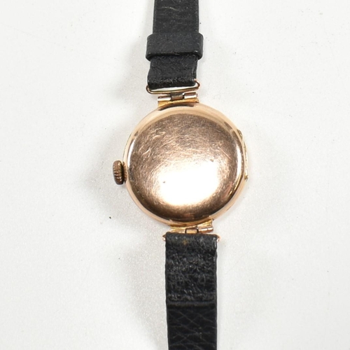 325 - A hallmarked 9ct gold wristwatch with a black strap. The watch having Roman numeral indices, spade h... 