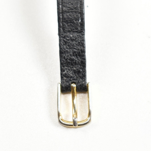 325 - A hallmarked 9ct gold wristwatch with a black strap. The watch having Roman numeral indices, spade h... 