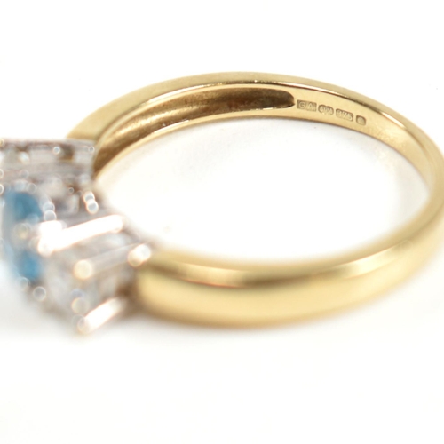 328 - A hallmarked 9ct gold, CZ and topaz three stone ring. The ring having a central four claw set round ... 