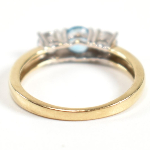 328 - A hallmarked 9ct gold, CZ and topaz three stone ring. The ring having a central four claw set round ... 