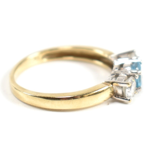 328 - A hallmarked 9ct gold, CZ and topaz three stone ring. The ring having a central four claw set round ... 