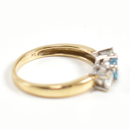 328 - A hallmarked 9ct gold, CZ and topaz three stone ring. The ring having a central four claw set round ... 