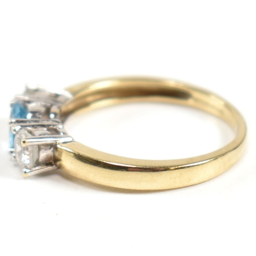 328 - A hallmarked 9ct gold, CZ and topaz three stone ring. The ring having a central four claw set round ... 