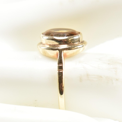 330 - A hallmarked 9ct gold and citrine ring. The ring having a bezel set oval cut citrine in a 9ct gold o... 