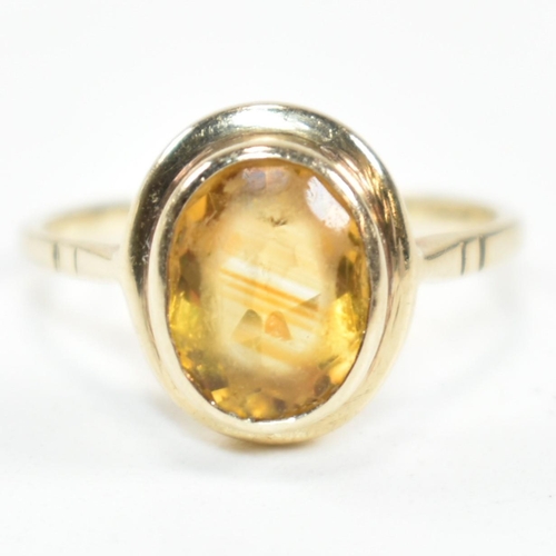 330 - A hallmarked 9ct gold and citrine ring. The ring having a bezel set oval cut citrine in a 9ct gold o... 