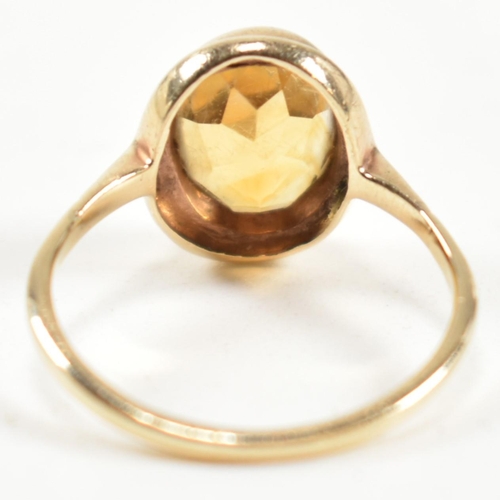 330 - A hallmarked 9ct gold and citrine ring. The ring having a bezel set oval cut citrine in a 9ct gold o... 