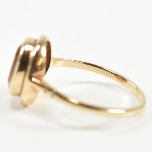 330 - A hallmarked 9ct gold and citrine ring. The ring having a bezel set oval cut citrine in a 9ct gold o... 