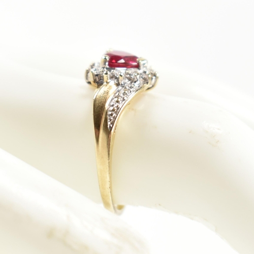 337 - A hallmarked 9ct gold, diamond and synthetic ruby cluster ring. The ring having a central heart cut ... 