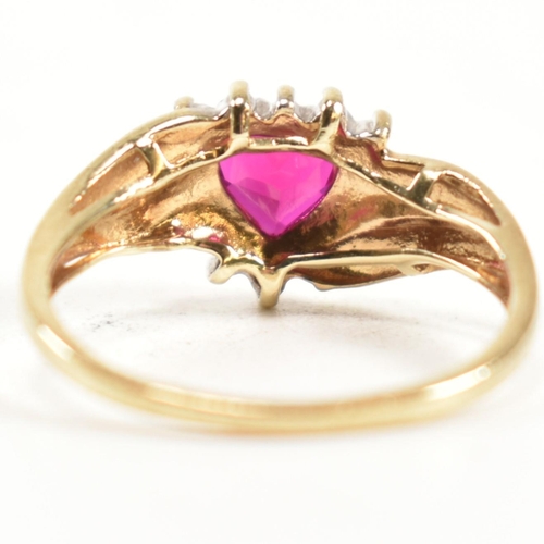 337 - A hallmarked 9ct gold, diamond and synthetic ruby cluster ring. The ring having a central heart cut ... 