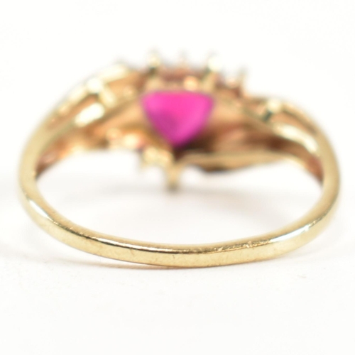 337 - A hallmarked 9ct gold, diamond and synthetic ruby cluster ring. The ring having a central heart cut ... 