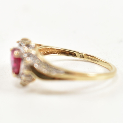 337 - A hallmarked 9ct gold, diamond and synthetic ruby cluster ring. The ring having a central heart cut ... 