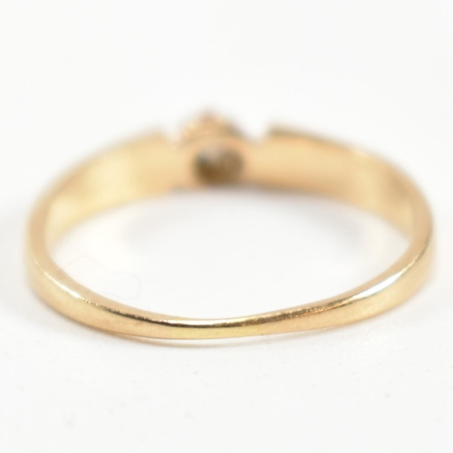 339 - A gold and diamond solitaire ring. The ring having a central round brilliant cut diamond set in a de... 