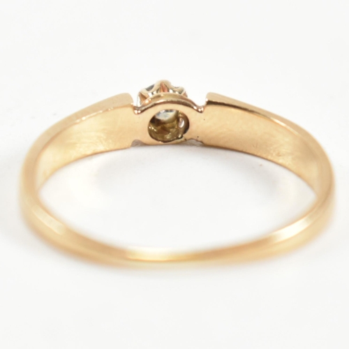 339 - A gold and diamond solitaire ring. The ring having a central round brilliant cut diamond set in a de... 