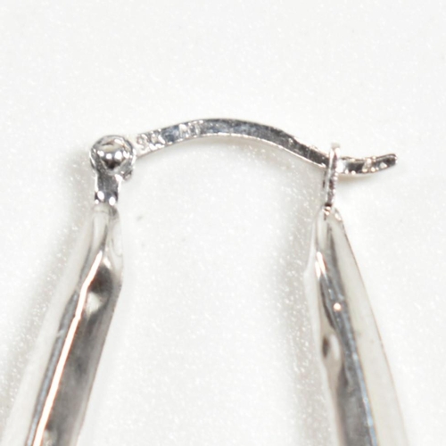 348 - Two pairs of 9ct white gold hoop earrings. The earrings to include a pair of hallmarked 9ct white go... 