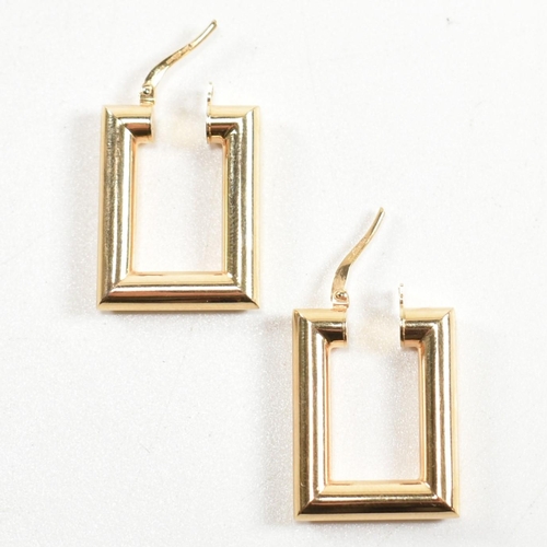 352 - A pair of hallmarked 9ct gold rectangular hoop earrings. The rectangular hoop earrings having a smoo... 