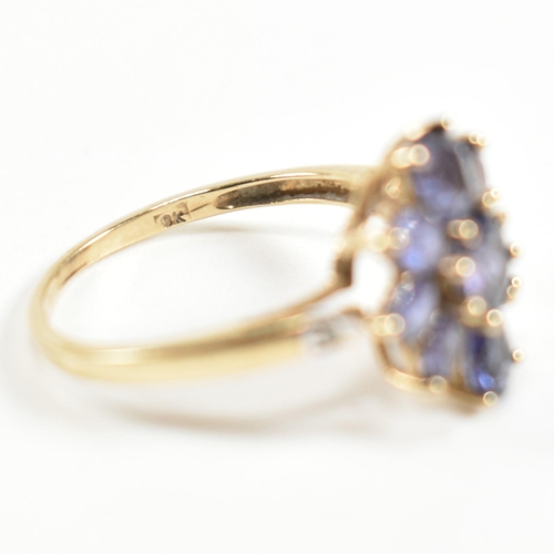 354 - A hallmarked 9ct gold and iolite cluster ring. The ring having a central eight claw set round cut io... 